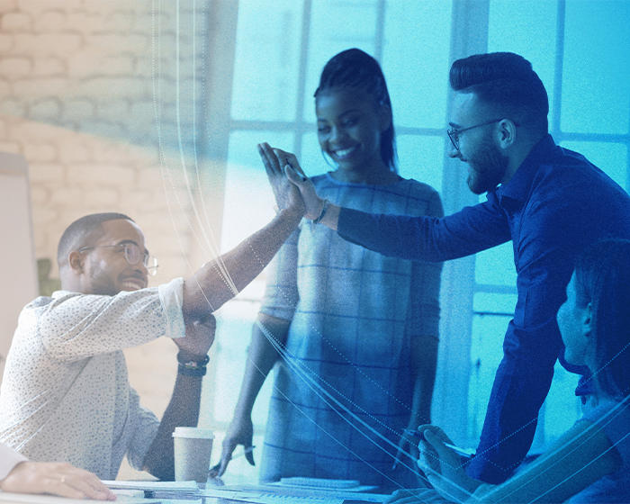 three employees high-fiving each other for job well done 